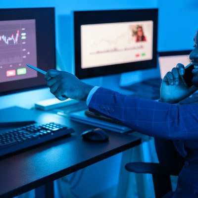 Businessman using graphs and all the technological resources to make the best investments. Businessman using graphs and all the technological resources to make the best investments.